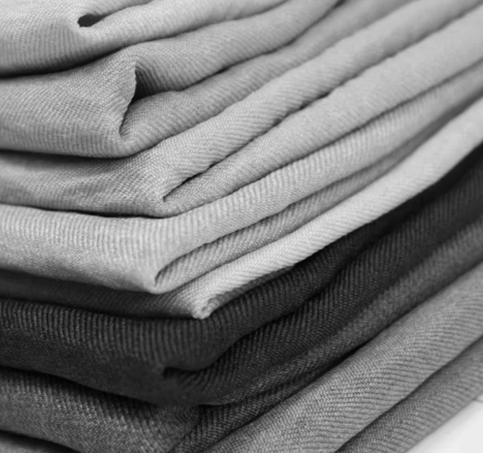 Neat stack of folded cotton and knit fabrics in grey and black